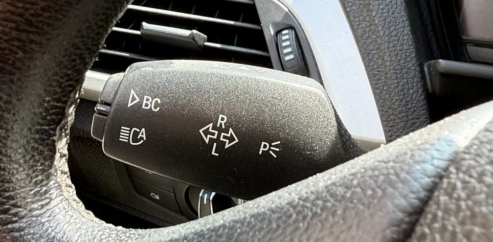 The icon shows that pressing the stalk changes the view