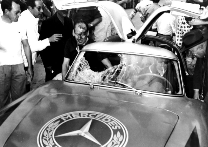 Kling and Lang climbing out of their damaged Mercedes 300SLR